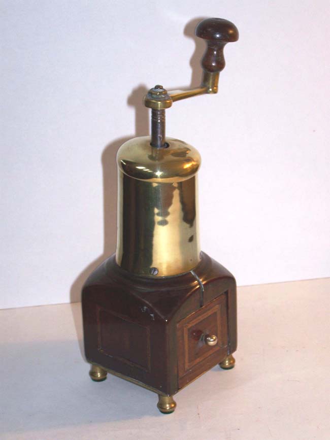 An English Queen Anne period Brass and Fruitwood Pepper Mill circa 1710.